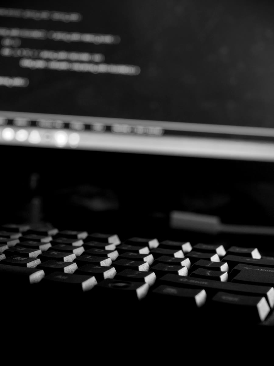 Programming code displayed above a computer keyboard