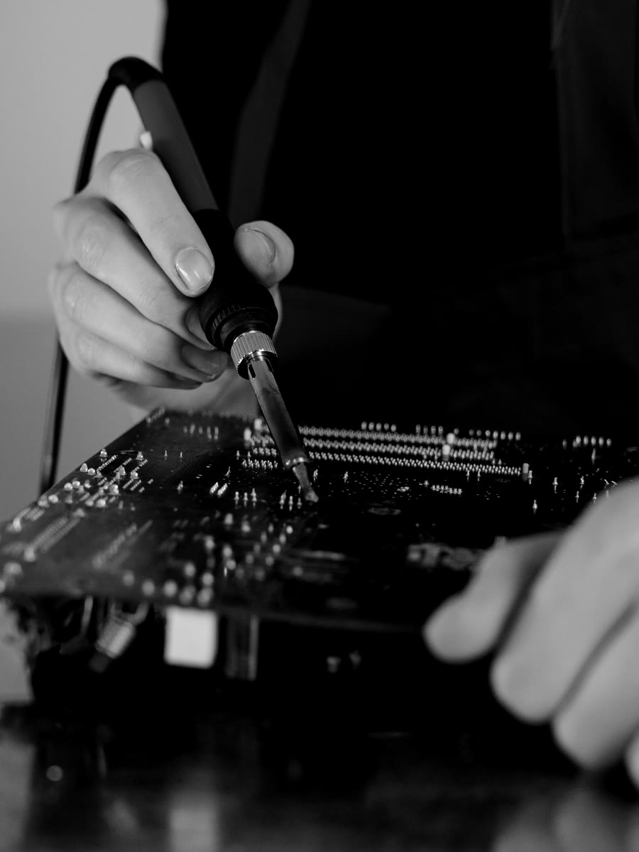 Hands soldering components on a circuit board